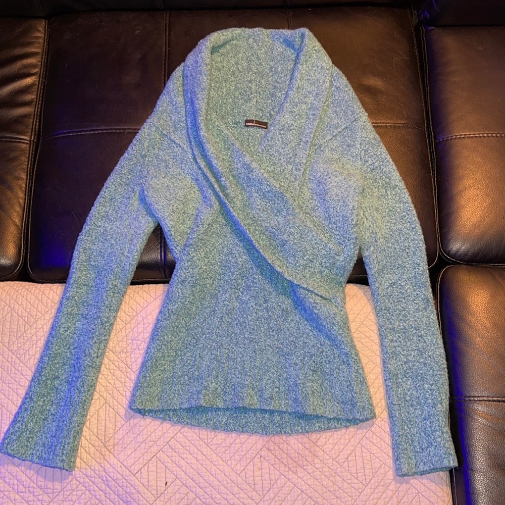 Super cute sweater color is greenish blue dark turquoise color.